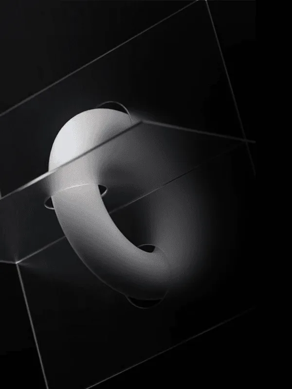 A pale glossy ring, twisted open like a letter C, floating where several sheets of clear glass cross in the dark