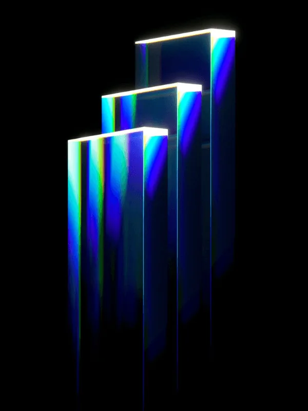 Three tall glass slabs standing side by side at rising heights, lit blue and green like a prism, reading as a bar chart